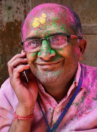 Man on the phone during Holi, the Festival of Colours, Delhi, India