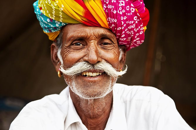 Rajasthani woman giving pose wearing traditional dress in front house  jodhapur rajasthan India MR